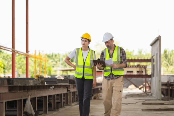 istock Caucasian engineer in hardhats discussing on construction site, Engineer and female foreman worker team checking project at precast concrete factory site 2155282798
