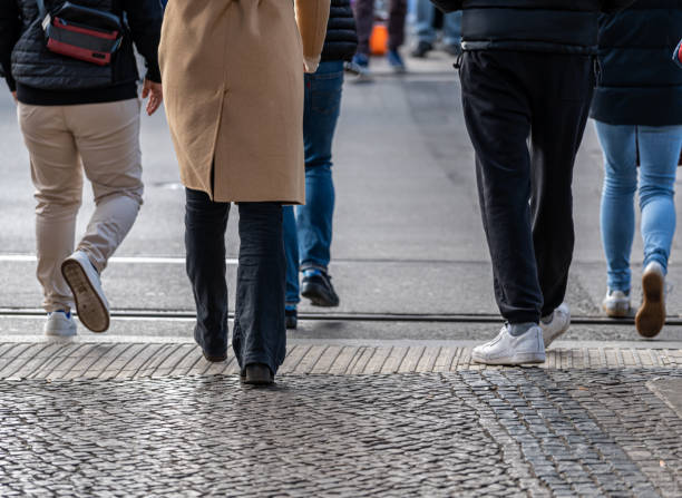 istock Low section view of people crossing road 2155288406