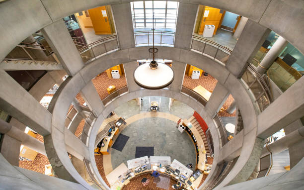 Modern building interior with curved floors, skylights and glass walls (Takasaki city central library)