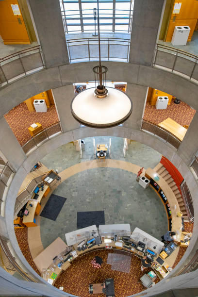 Vancouver, Canada - August 17, 2023: Tourists walking in the entrance hall of the Vancouver Public Library Building - VPL.