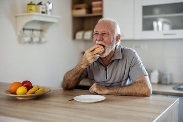 istock Portrait of a senior man eating an apple. 2155294500