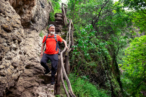 Active senior man hiking in the jungle