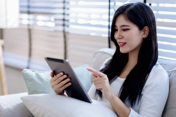 istock young woman looking at tablet screen holding credit card, using mobile tablet secured online e-banking app, satisfied with online cashback purchase or good electronic banking services. 2155298519
