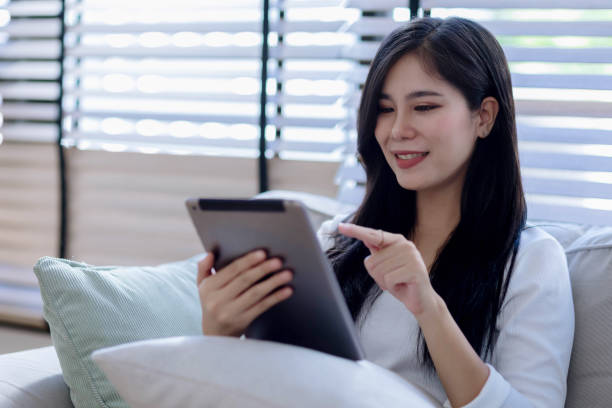 istock young woman looking at tablet screen holding credit card, using mobile tablet secured online e-banking app, satisfied with online cashback purchase or good electronic banking services. 2155298522