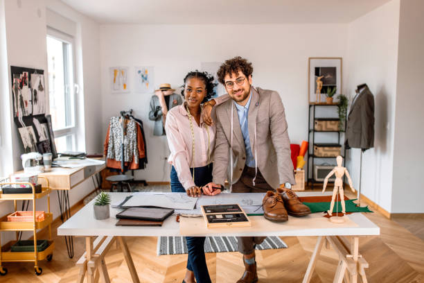 istock Portrait of two tailors working together in clothes design studio 2155298716
