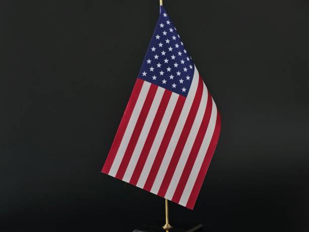 istock Small American Flag on Stand on Black Background 2155298832