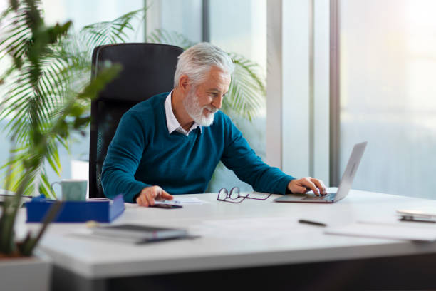 istock Senior white-haired businessman working in office 2155298916