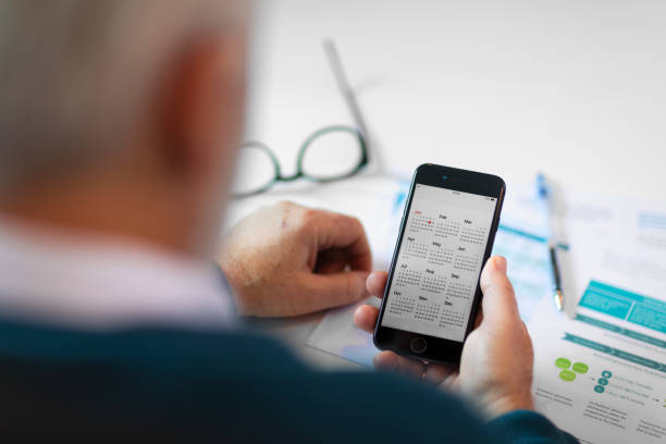 Senior white-haired businessman using a smart-phone