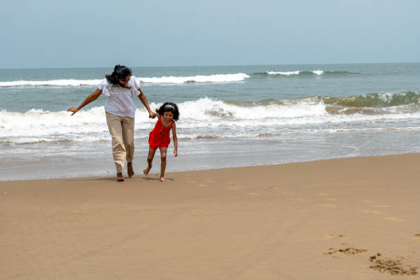 This image is about Beach Bonding Joyful Parent-Child Play