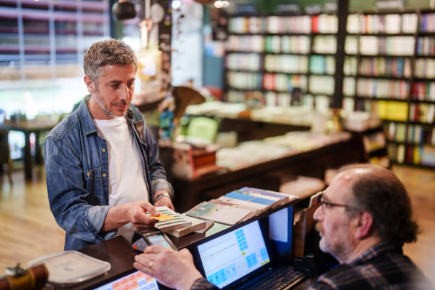 istock Contactless payment at the bookstore with credit card. 2155300821