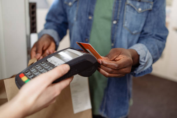 istock Customer making a payment to delivery person using a credit card 2155300825