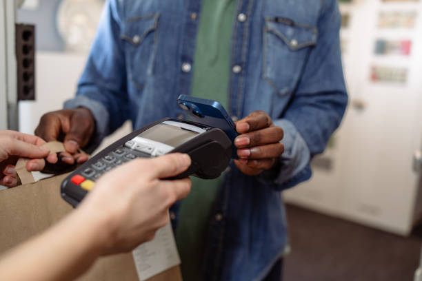 istock Man using mobile phone for contactless delivery payment at the doorway 2155300852