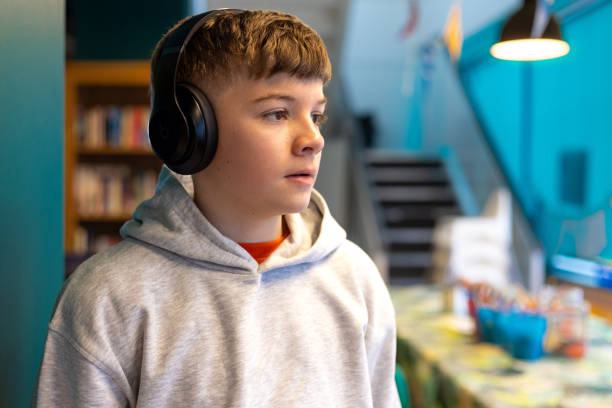istock Young Boy Listening to Headphones 2155305084