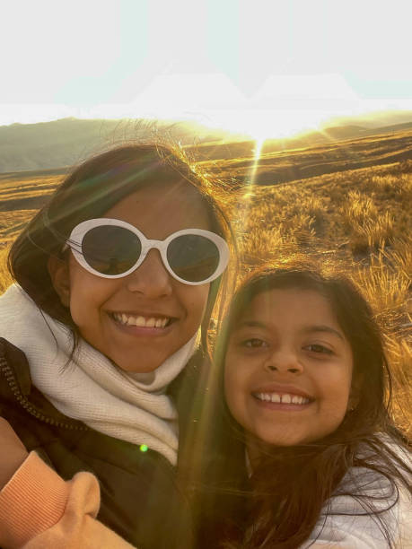 istock Two young girls are smiling and wearing sunglasses 2155308384