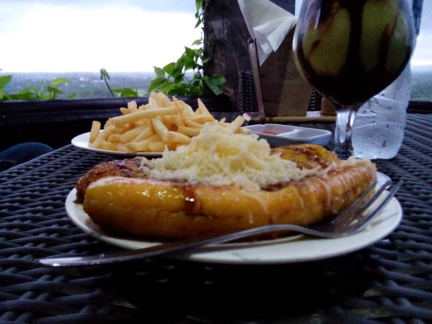 eating potatoes and grilled bananas outdoors. There are also drinks as a tired medicine. eat a restaurant menu and eat while looking at the view
