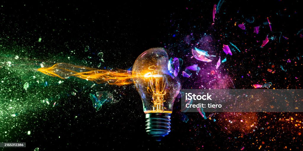 Exploding Light Bulb Concept On Dark Background Stock Photo - Download ...