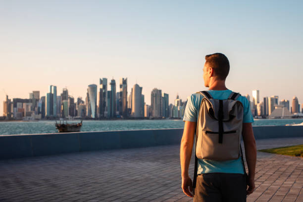 Man looking at urban skyline of Doha