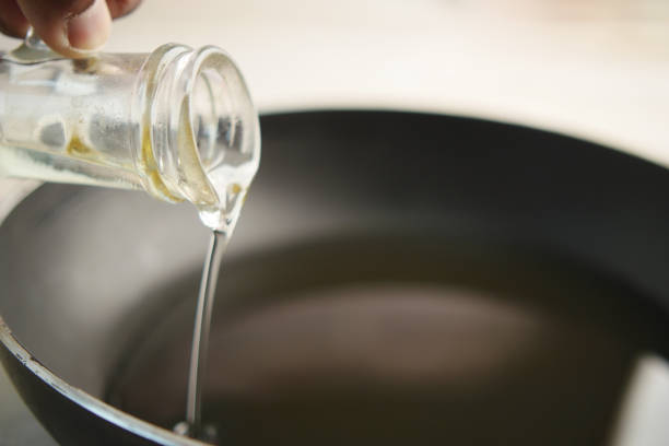 istock Pouring vegetable oil into frying pan. 2155315675