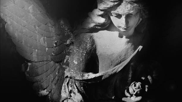 istock Black and white image of angel in the sunlight (antique statue) 2155315835