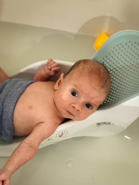 istock A new born baby boy in the bath for the first time 2155317830
