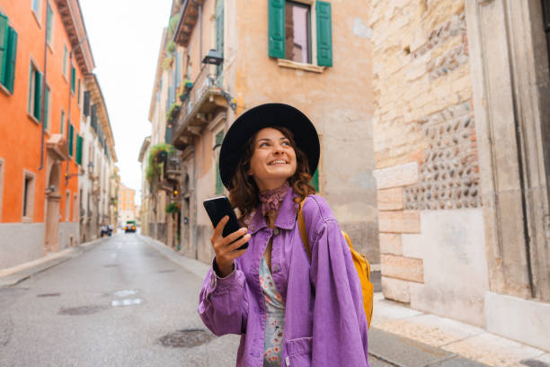Woman using smartphone exploring in Verona