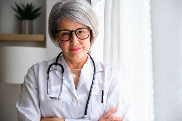 istock A female doctor in a white lab coat is smiling and looking at camera 2155319982