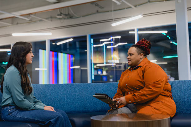istock Diverse Female Co-workers Meet to Discuss Project 2155322322