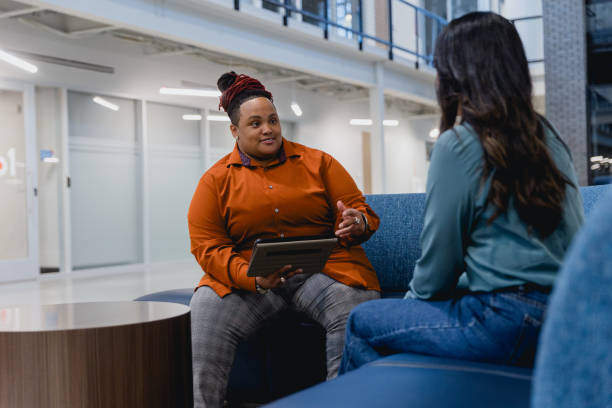 istock Diverse Female Co-workers Meet to Discuss Project 2155322326
