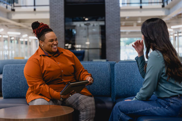 istock Diverse Female Co-workers Meet to Discuss Project 2155322329