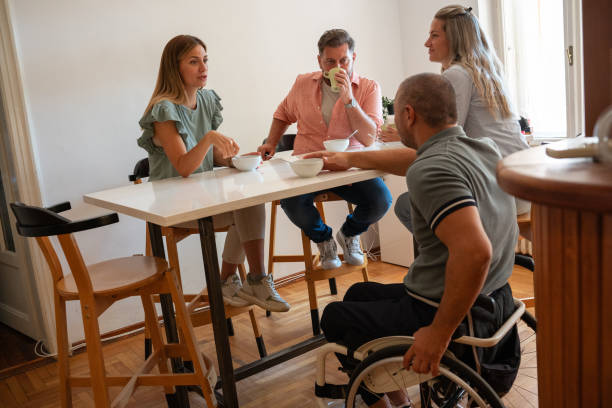 istock Office workers take a coffee break in the company cantina, chatting and laughing around a table. 2155323145