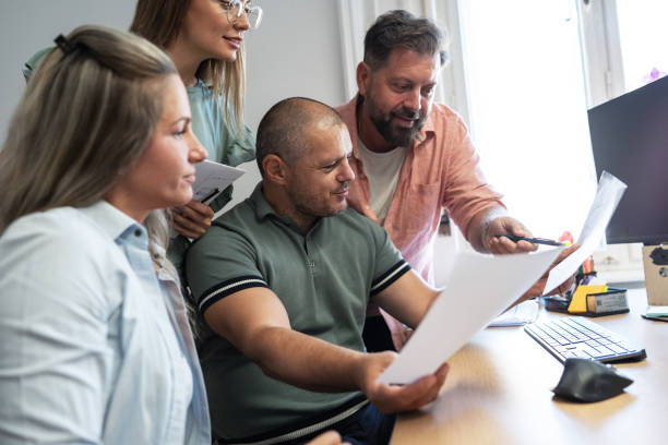 istock Group of independent journalists at the office 2155323211