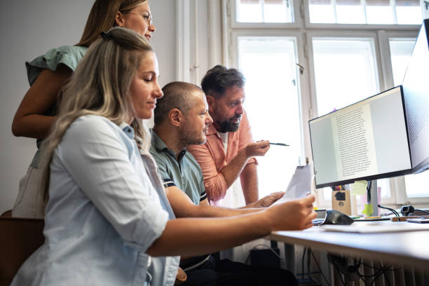 istock Group of independent journalists at the office 2155323216