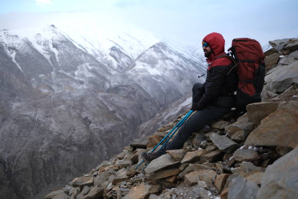 istock Successful man backpacker hiking in winter mountains 2155323938
