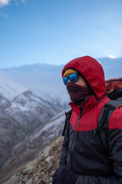 istock Successful man backpacker hiking in winter mountains 2155323946