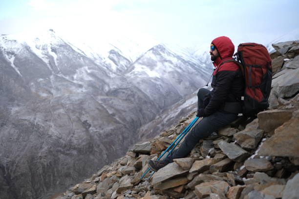istock Successful man backpacker hiking in winter mountains 2155324025