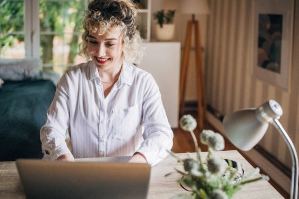 istock Smiling woman during home office call 2155326632