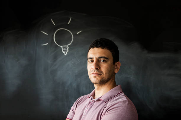 Front View Of Young Man With Light Bulb On The Head stock photo
