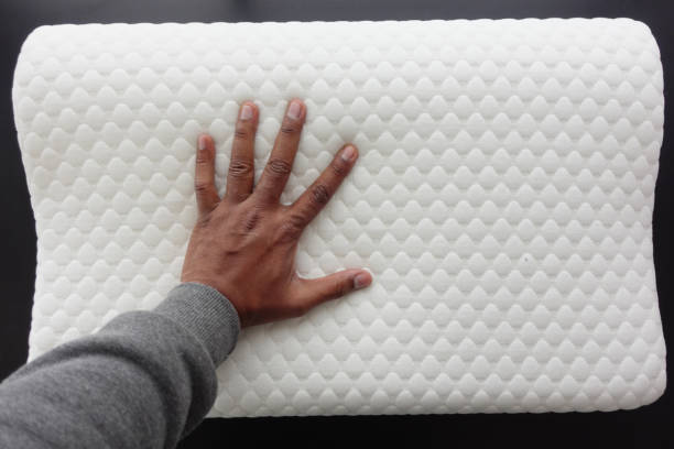 istock man hand on Orthopedic pillow on a bed 2155330680