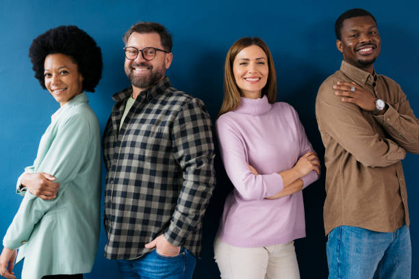 istock Confident businesspeople standing together against blue background 2155333408