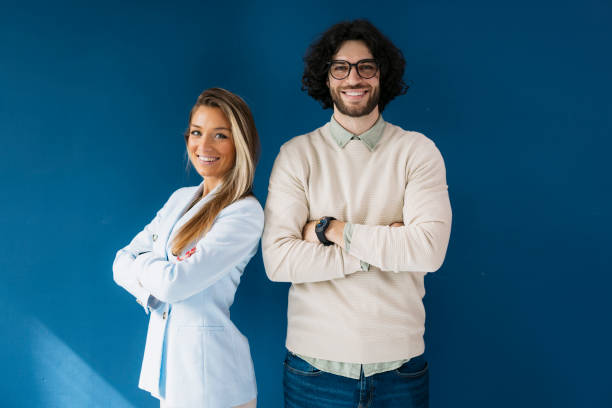 istock Smiling young people looking at camera together against blue background 2155334265