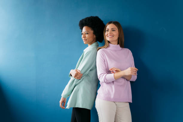 istock Two confident businesswomen standing back to back looking away 2155334611