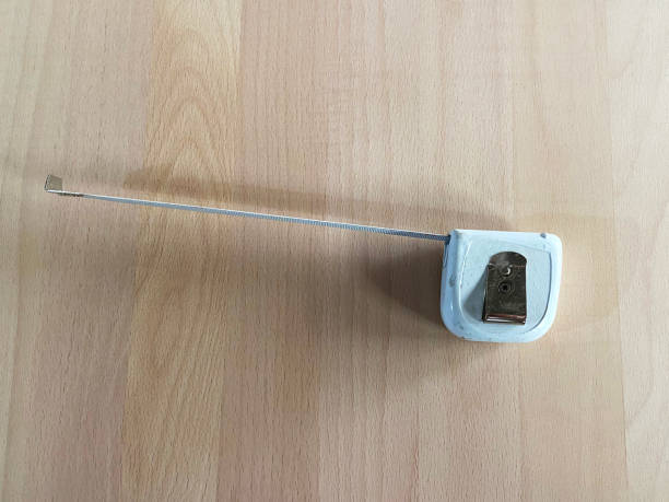 istock Tape measure, meter on the wood background 2155336937