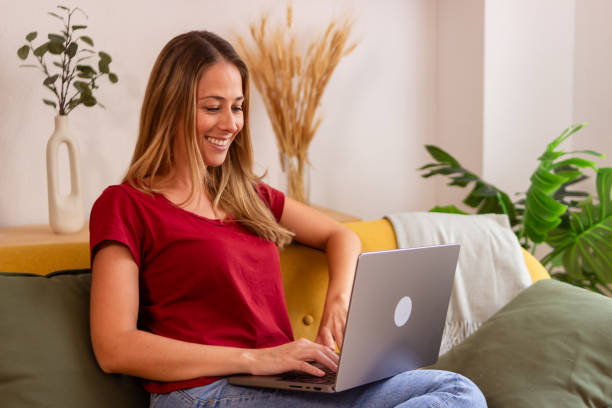 istock Young woman working on laptop at home 2155338706