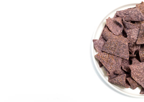 istock Top View Mockup Isolated Organic Blue Corn Tortilla Chips On Half Plate, White Background. Healthy Crunchy Snack Seasoned With Sea Salt. Design Horizontal Plane. Copy Space. 2155338725