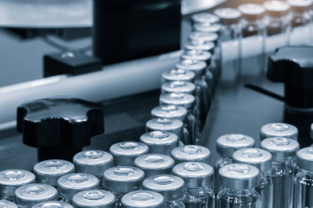 istock Pharmaceutical industry. Production line machine conveyor with glass bottles ampoules at factory. Pharmaceutical industry concept background. 2155338872