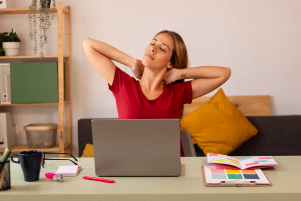 istock Young woman taking a break at home office 2155338944