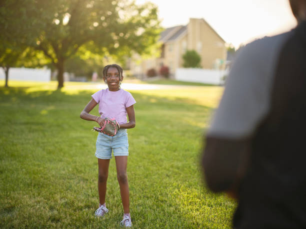 istock Grandfather and Granddaughter Practicing Baseball in a Park 2155340276