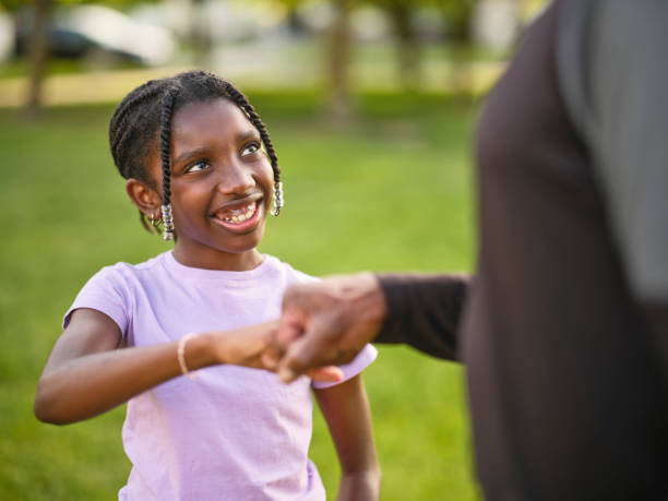 istock Grandfather and Granddaughter Practicing Baseball in a Park 2155340447