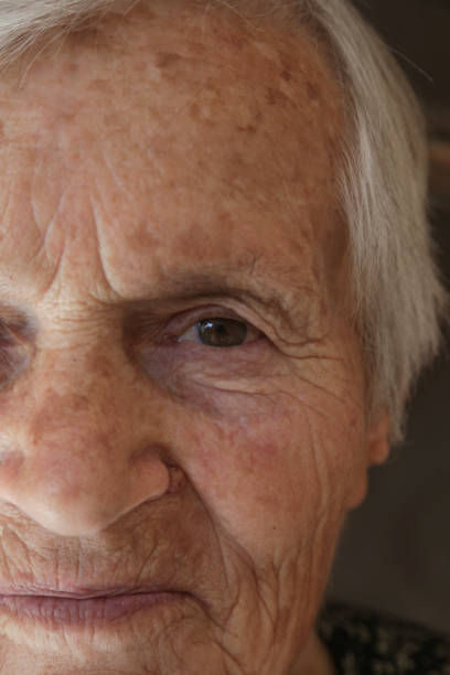 Portrait of smiling mature old woman aged 80s outdoors