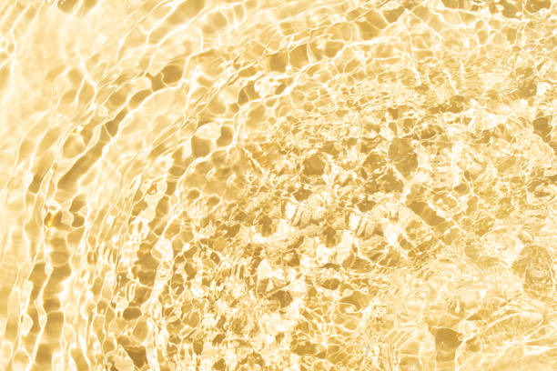 istock Water with shining wave texture on a vibrant pastel yellow background. 2155342485